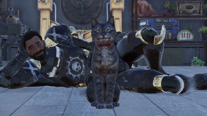 A man lies on the floor behind his cat in a red bow in Fallout 76.