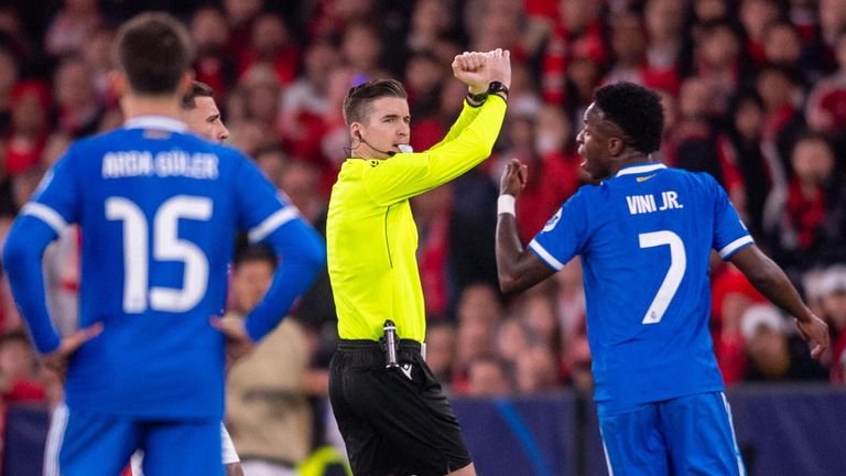Referee Francois Letexier crosses his arms to activate FIFA's anti-racism protocol and temporarily stop the match